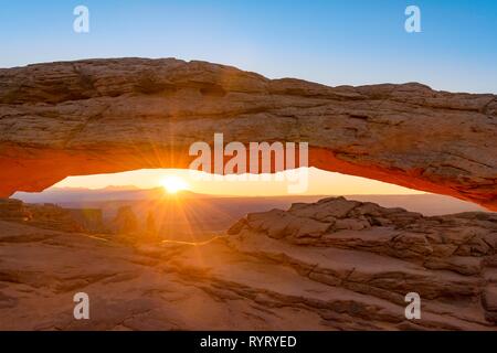 View through rock arch, Mesa Arch, sunbeams, sunrise, Grand View Point Road, Island in the Sky, Canyonlands National Park, Moab Stock Photo