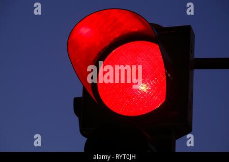 Traffic light shows red at dusk, Germany Stock Photo
