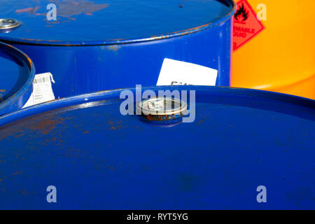 Top of 200 litre 55 US gallon empty gasoline drums in storage area awaiting pick up Stock Photo