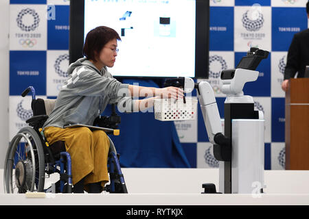 Tokyo, Japan. 15th Mar, 2019. The Human Support Robot, which may be used in Tokyo 2020 Olympic and Paralympic Games, delivers goods to a staff in wheelchair in Tokyo, Japan, on March 15, 2019. The Tokyo 2020 Organizing committee announced the launch of its new Tokyo 2020 Robot Project on Friday. Credit: Du Xiaoyi/Xinhua/Alamy Live News Stock Photo