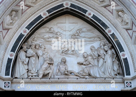 Sculpted lunette containing a relief of the Triumph of the Cross, by Giovanni Dupre, over central door of the of Basilica of Santa Croce in Florence Stock Photo