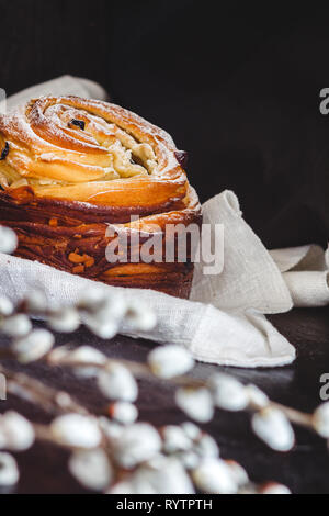 Easter cake kranch with icing sugar on a dark background and with willow flowers. Stock Photo