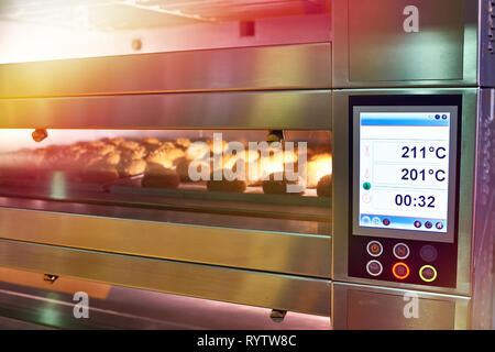 LCD screen of oven with bread in the bakery Stock Photo