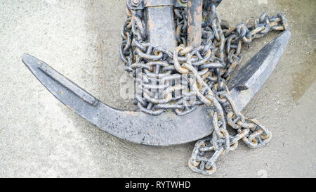 The anchor with lots of chains on the floor of the ship Stock Photo