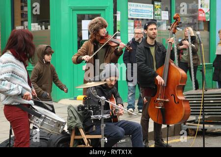 Group of buskers in London street with double bass, violin and drums Stock Photo