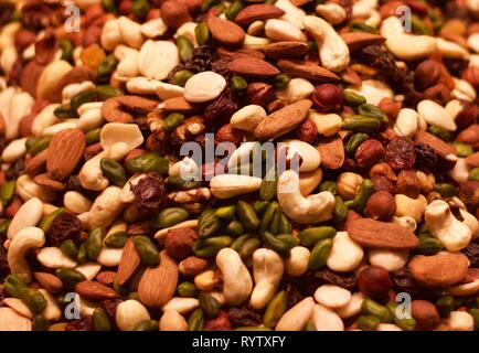 Background showing healthy food including almonds, cashew nuts and other dried fruit and nuts Stock Photo
