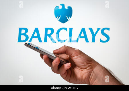 A man using Barclays Bank online banking on his mobile phone Stock Photo