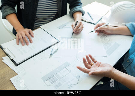 Engineer discussing meeting working on blueprint project architectural at construction site Stock Photo
