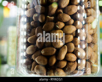 Nut mix in glass jars, hazelnuts, almonds, cashew on white background. Selective focus, copy space. Stock Photo