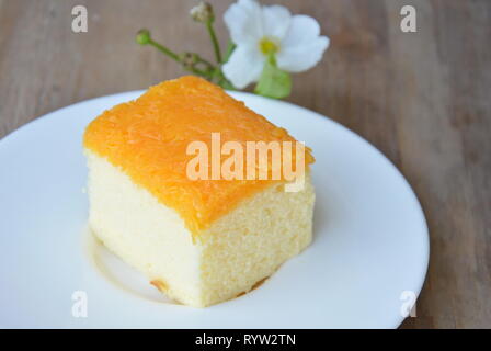 butter cake topping golden egg strips on dish Stock Photo