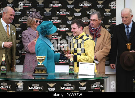 The Princess Royal presents Jockey Paul Townend (right) with the trophy after winning the Magners Cheltenham Gold Cup Chase on Al Boum Photo during Gold Cup Day of the 2019 Cheltenham Festival at Cheltenham Racecourse. Stock Photo