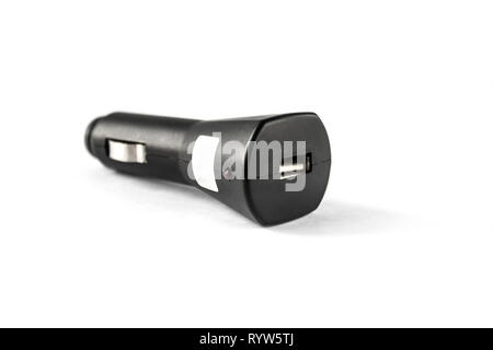 Car charger on a white background. Car cigarette lighter, for player, for e-books, for tablet, for phone, smartphone, universal. Stock Photo