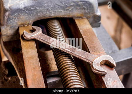 Rusty old vintage wrench on industrial equipment isolated Stock Photo