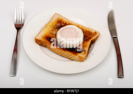 Poached egg on toast Stock Photo