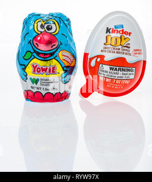 Winneconne, WI - 10 March 2019: A package Yowie chocolate egg and Kinder joy egg both of which have surprise inside on an isolated background Stock Photo