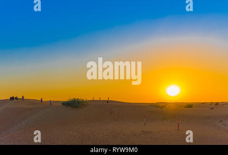 Sunset over sand dunes in Dubai Desert Conservation Reserve, United Arab Emirates. Copy space for text Stock Photo