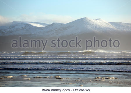Snowy mountains and stormy beach at Inch County Kerry along the Wild Atlantic Way Stock Photo