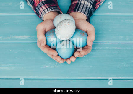 Female hand holding Easter eggs in hands Stock Photo