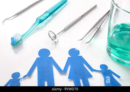 Professional family concept dentist with tools on white table. Horizontal composition. Elevated view Stock Photo