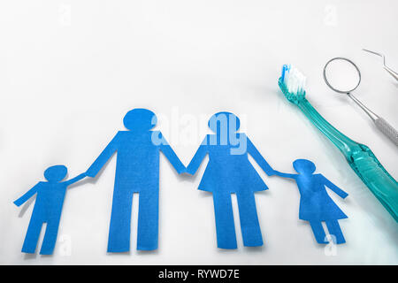 Professional family concept dentist with tools on white table. Horizontal composition. Elevated view Stock Photo