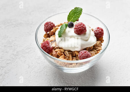 Granola, yougurt and raspberries in bowl Stock Photo