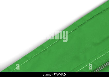 Edge of a green windbreaker on a white background, placed so as to cut the composition  in two diagonally Stock Photo