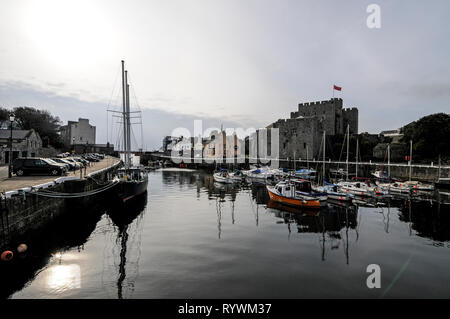 Castletown harbour at low tide and Castle Rusehen in Castletown on the south coast of the Isle of Man, Britain.   The town was the seat of Government  Stock Photo