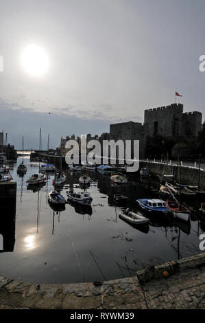 Castletown harbour at low tide and Castle Rusehen in Castletown on the south coast of the Isle of Man, Britain.   The town was the seat of Government  Stock Photo