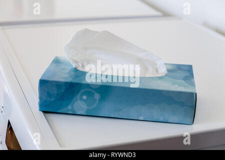 Blue Box of Paper Hankies or tissues on top of a kitchen appliance Stock Photo