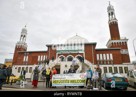 People stand in solidarity outside Birmingham Central Mosque during Friday prayers after the attack on the Mosque in Christchurch, New Zealand. Stock Photo