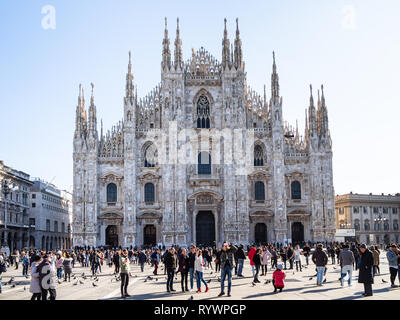 MILAN, ITALY - FEBRUARY 24, 2019: people on square Piazza del Duomo in front of Milan Cathedral (Duomo di Milano) in Milan city in morning. This Basil Stock Photo