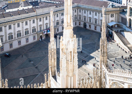 MILAN, ITALY - FEBRUARY 24, 2019: above view of tourists near Palazzo Reale on Piazza del Duomo from Milan Cathedral (Duomo di Milano) roof in morning Stock Photo