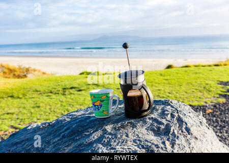 Coffee cup and french Press on rocks with wonderful Bayview, Northland New Zealand Stock Photo