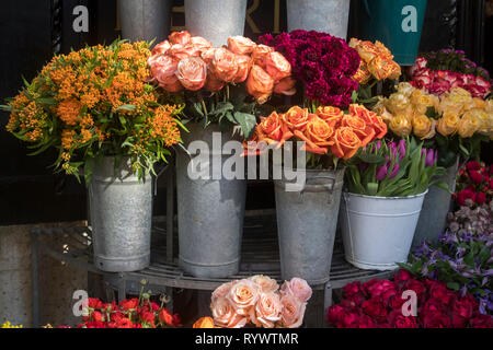 Many different spring flowers in baskets for bouquets on sale in the market Stock Photo