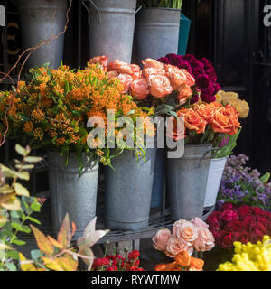 Many different spring flowers in baskets for bouquets on sale in the market Stock Photo