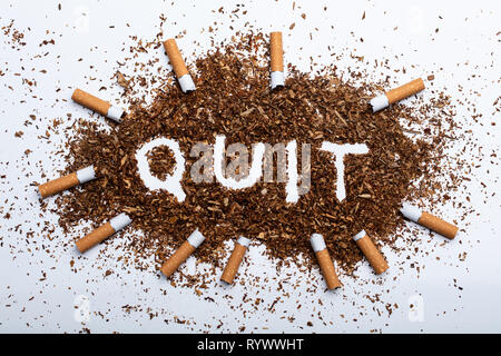 An Elevated View Of Frame Made With Broken Cigarettes Around Quit Word Written On Tobacco Stock Photo