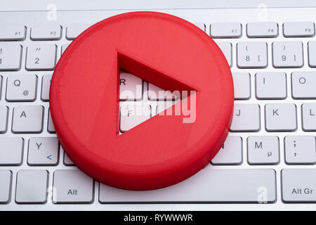 An Elevated View Of Red Play Button On White Keyboard Stock Photo