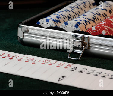 A poker scene with cards, chips and green felt.  Poker game, dark background. Stock Photo