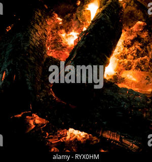 A campfire burning down to coals.  Close up shot of a camp fire or fire pit. Stock Photo