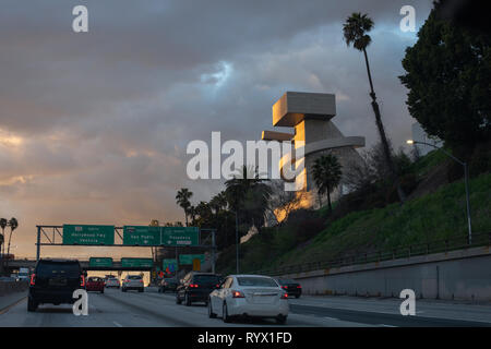 Busy evening traffic in downtown LA on 101 freeway next to the Ramon C. Cortines School of Visual and Performing Arts. Stock Photo