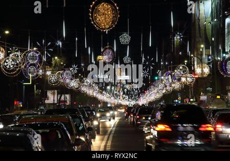 Bucharest, Romania - December 03, 2016: Cars in traffic with outdoor Christmas lights decorations in Bucharest, Romania. Stock Photo