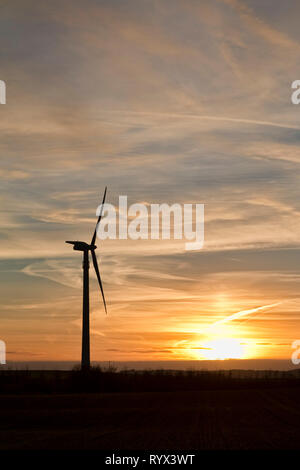 Wind turbine in the sunset. Can be used as background Stock Photo