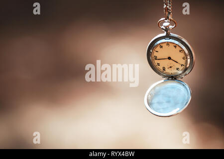 retro clock on a rope on a beautiful background Stock Photo