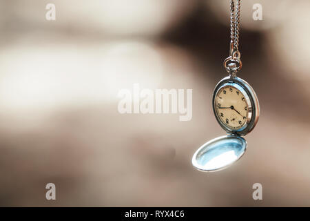 retro clock on a rope on a beautiful background Stock Photo