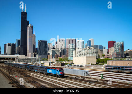 A train passes in front of the Chicago city Skyline in a Bright Sunny Day with blue sky Stock Photo