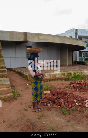 Nigerian woman working in the construction site as carrying sand with a basket in their heads Stock Photo