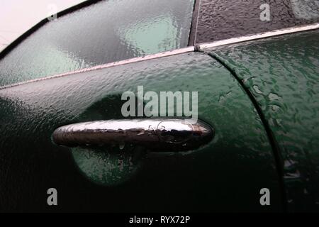 Bucharest, Romania -  January 24, 2019: A Mini car is glazed with ice after an winter ice storm, in Bucharest, Romania. Stock Photo