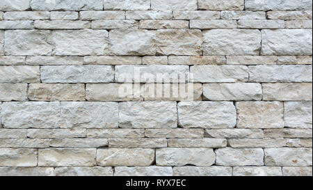 Gray dry stone wall of coarse natural stones Stock Photo