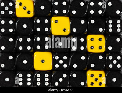 Background of random ordered black dices with five yellow cubes Stock Photo