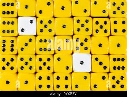 Background of random ordered yellow dices with two white cubes Stock Photo